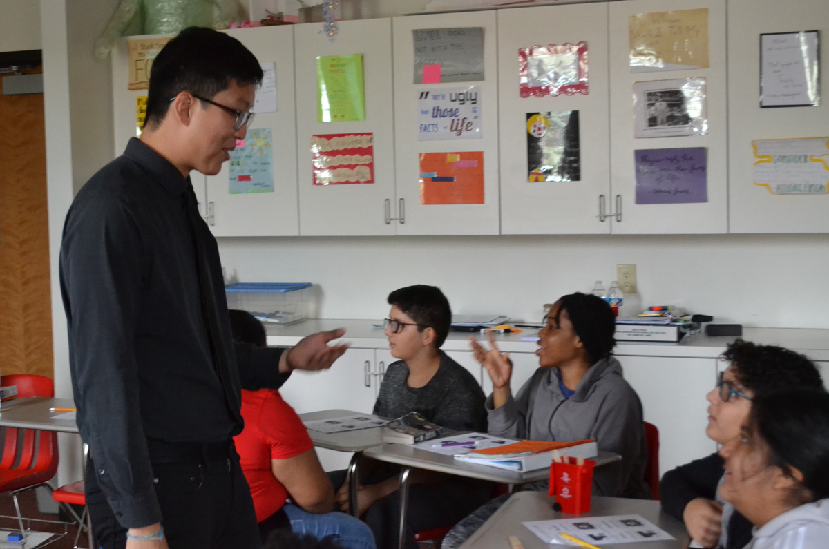 Daniel Koh talking with students at their desks